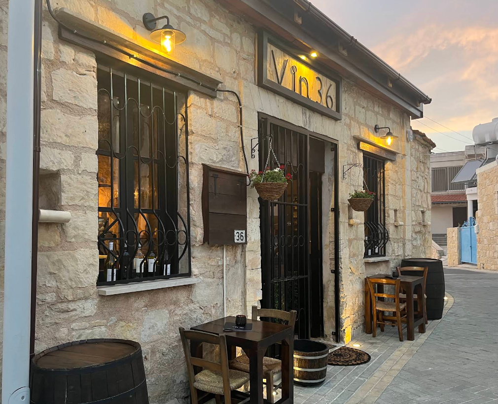 Stone facade of VIN 36 wine bar in Tsada at golden hour